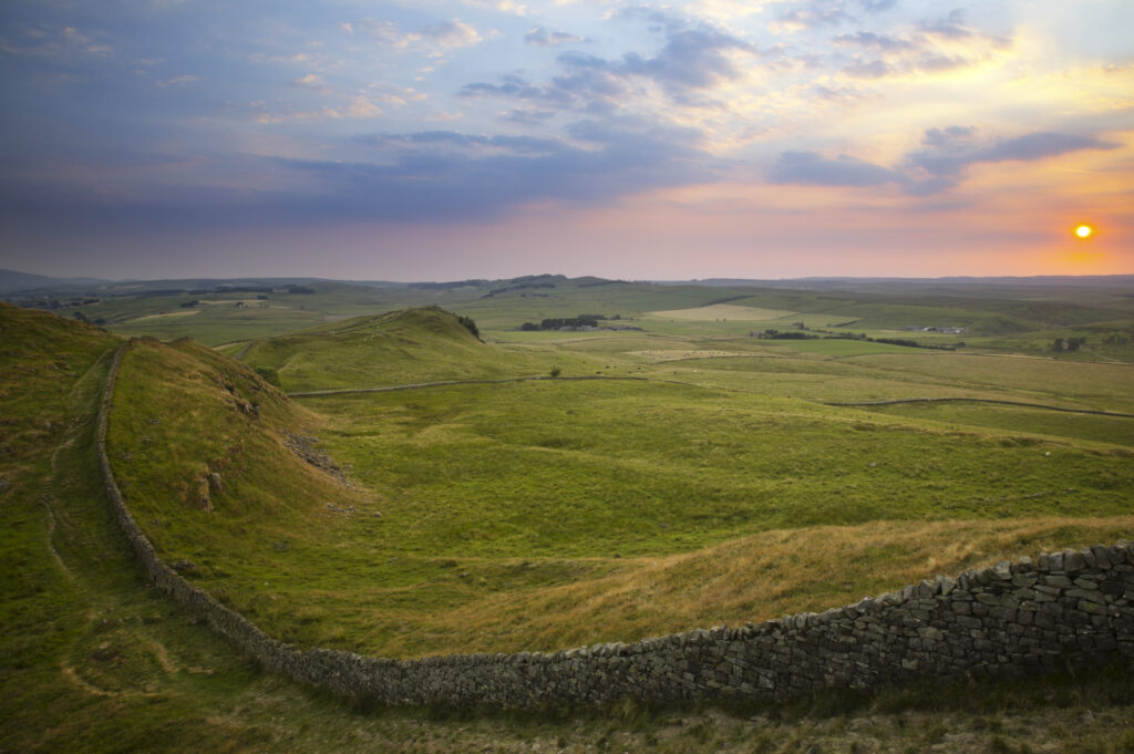 ENGLAND Northumberland Hadrians Wall Sunset behind the world heritage site of Hadrians Wall near the town of Once Brewed.