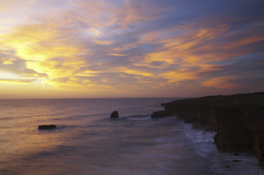 England, Tyne and Wear, Marsden Bay. Sunrise over the North Sea, near Lizard Point and Marsden Bay.