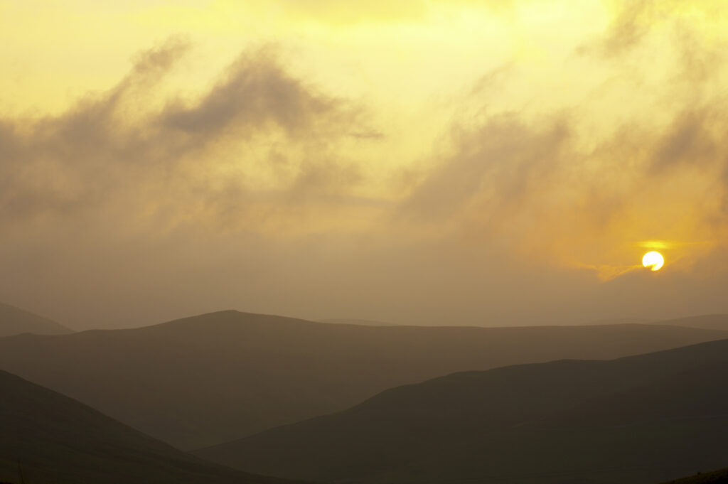 England, Northumberland, Northumberland National Park. Sunset over the rolling Cheviot Hills, viewed from the Border Coutry Ride route near Murder Cleugh.