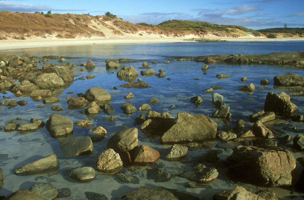 AUSTRALIA, Western Australia, Peaceful Bay. Soft light illuminates the rocks and white sands of this beach part of Walpole National Park