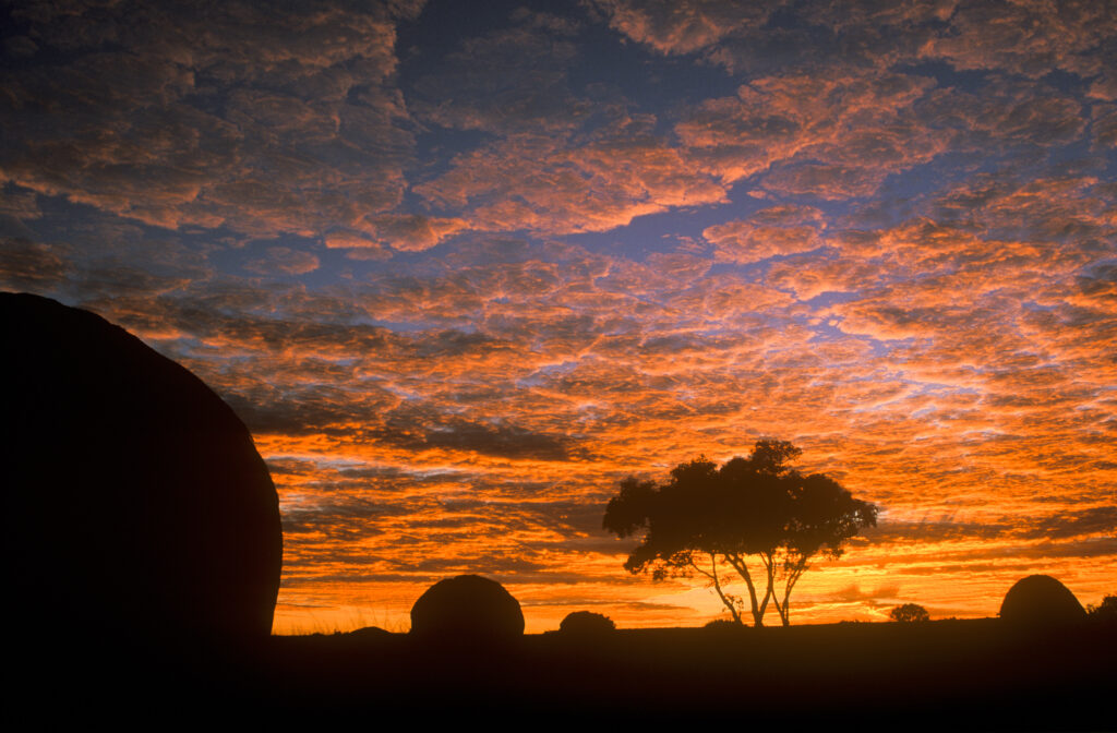 AUSTRALIA, Northern Territory, Devils Marbles. The pre dawn colours silhoutte the boulders of this popular tourist destination
