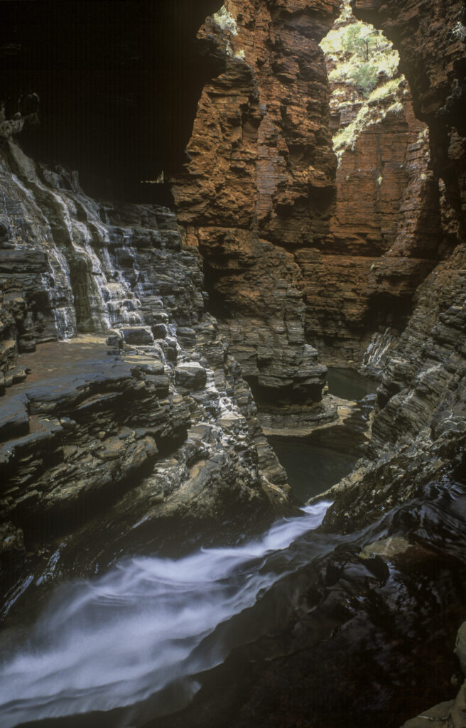 AUSTRALIA, Western Australia, Karajini National Park. Flowing water running through the narrow walls of Hancock Gorge.
