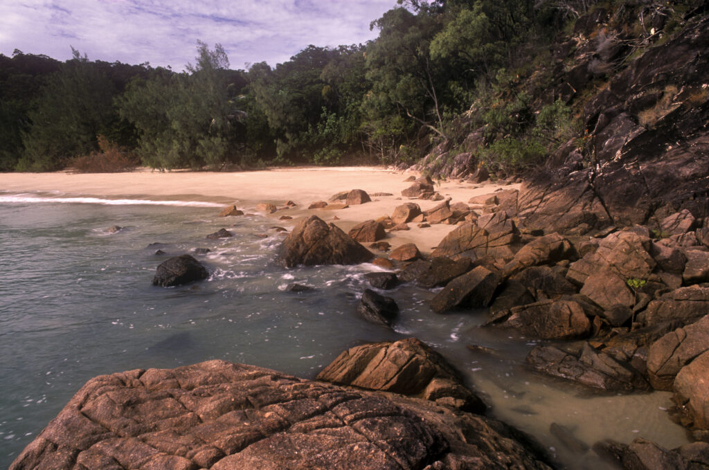 AUSTRALIA, Queensland, Hinchinbrook Island National Park. A rocky bay on the Thorsborne Trail