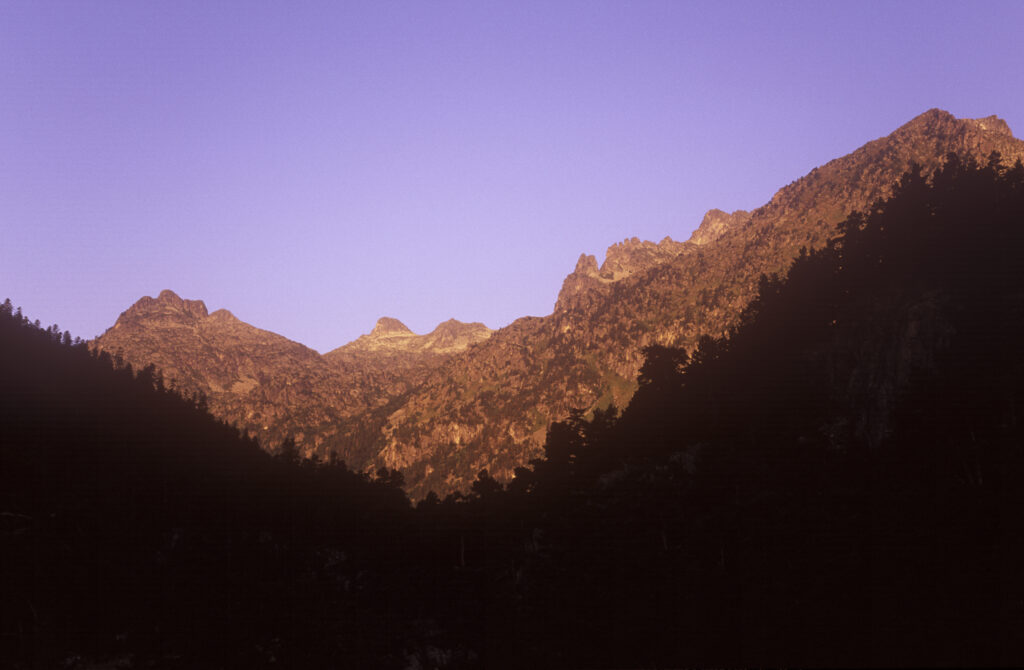 FRANCE, Midi Pyrenees, Pyrenees National Park. Early morning light illuminates the peaks of the park found by Pont d Espagne