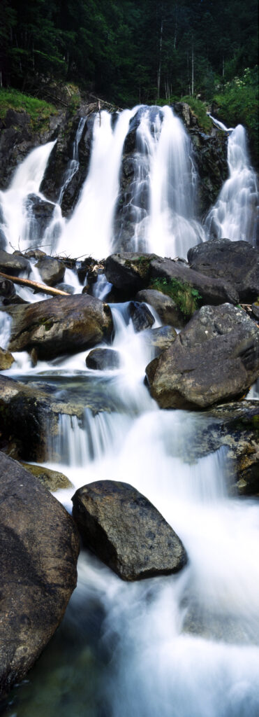 FRANCE, Midi Pyrenees, Pyrenees National Park. The flowing waters of the Cascades de Lutour and surrounding forest