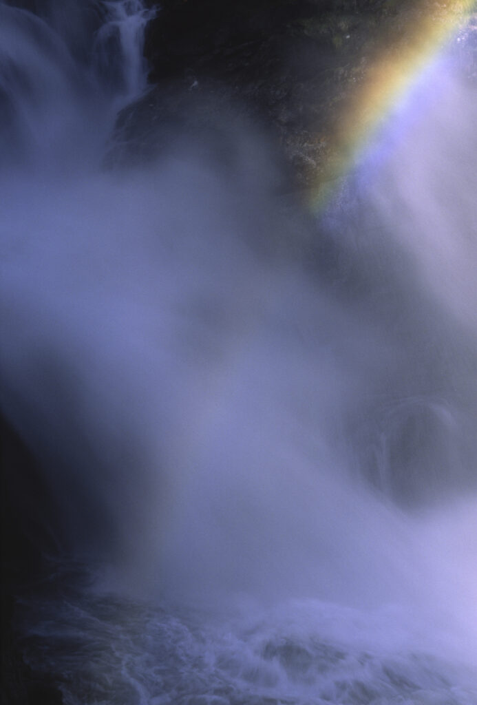 ITALY, Valle d'Aosta, Gran Paradiso National Park. A rainbow forms over the spectacular waterfall of the cascades of Lillaz in the western alps.