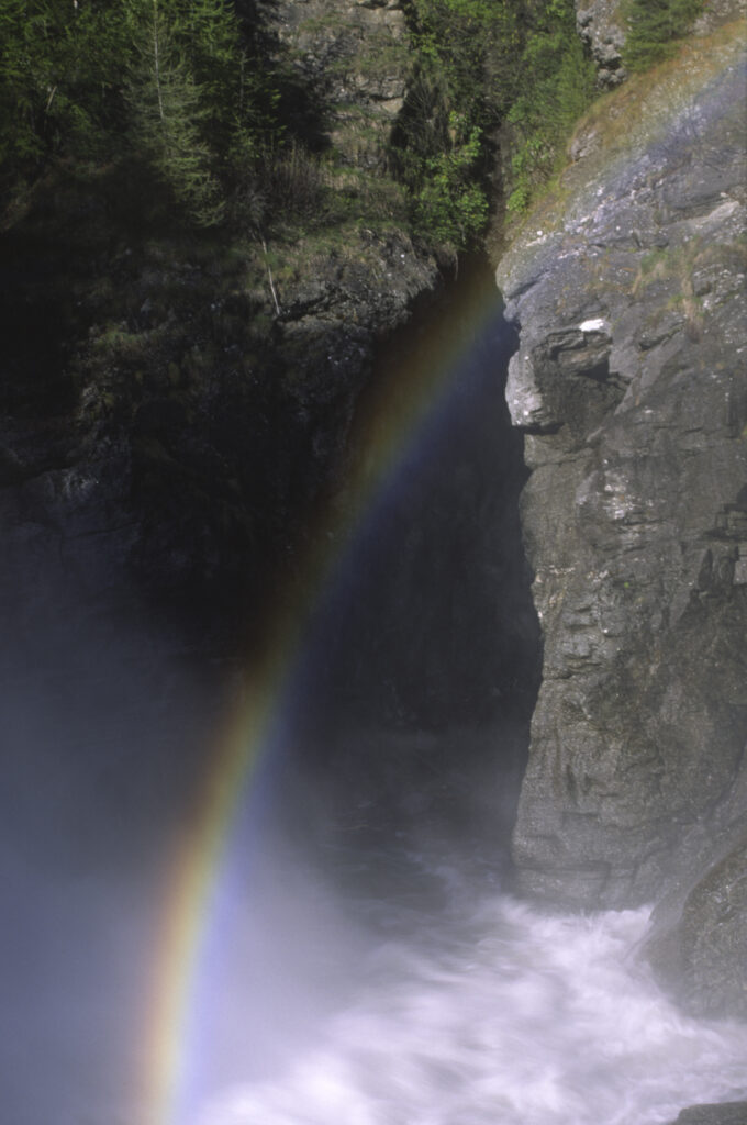 ITALY, Valle d'Aosta, Gran Paradiso National Park. A rainbow forms over the spectacular waterfall of the cascades of Lillaz in the western alps.