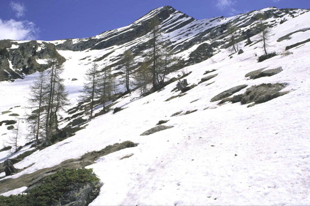 ITALY, Valle d'Aosta, Gran Paradiso National Park. Snow remains well into spring in the peaks of the mountain landscape of the western Alps above the Lillaz valley.