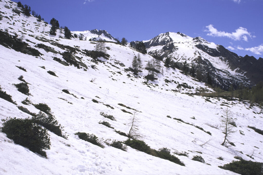 ITALY, Valle d'Aosta, Gran Paradiso National Park. Snow remains well into spring in the peaks of the mountain landscape of the western Alps above the Lillaz valley.