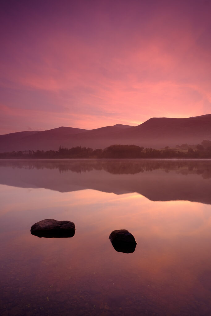 England, Cumbria, Lake District National Park. The colours of dawn reflected in the still waters of Thirlmere Reservoir, which supplies about 11% of North West England’s water supply.