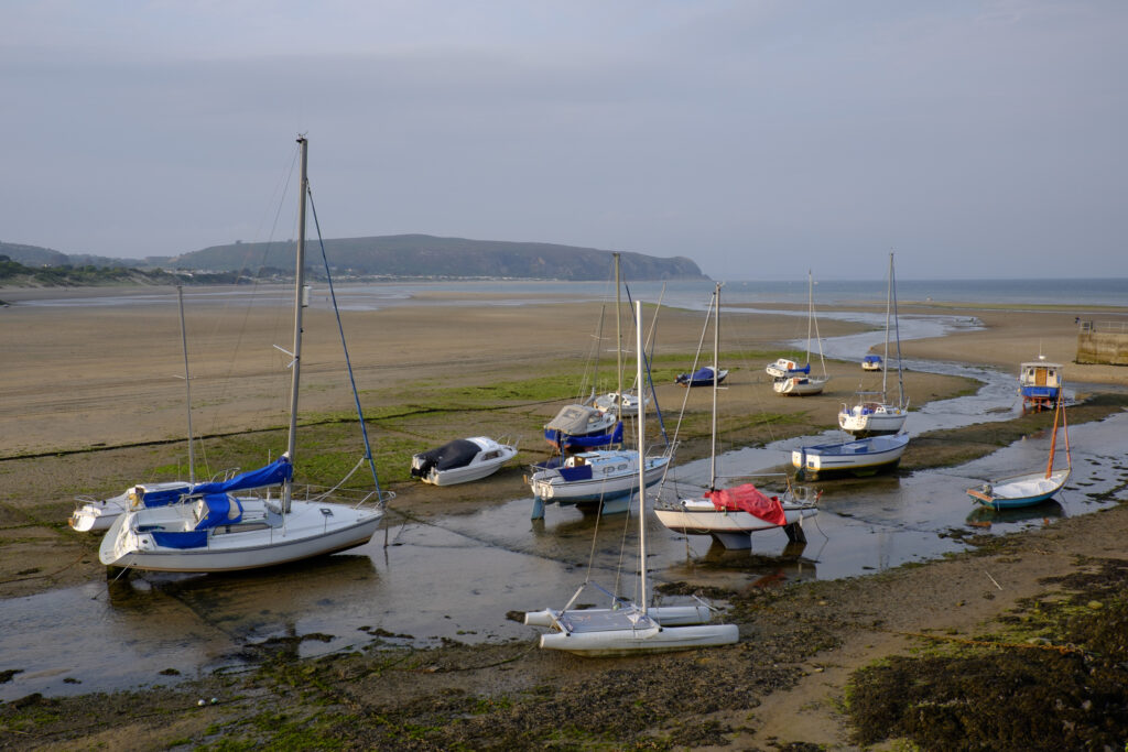 Wales, LLeyn Peninsula, Abersoch. Boats moored at low tide on the vast sandy beach at Abersoch on the LLeyn Peninsula. -- Portal Editing Team selected this image for stockbyte.