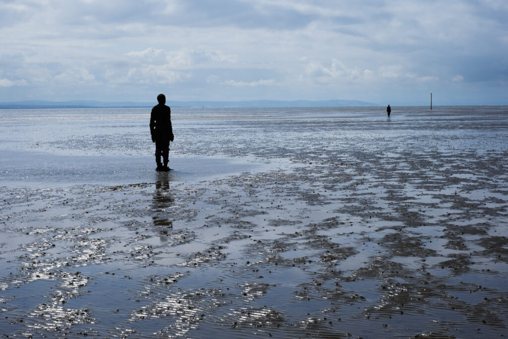 England, Merseyside, Antony Gormley Another Place. Antony Gormley sculptures at Crosby Beach near Liverpool in England.
