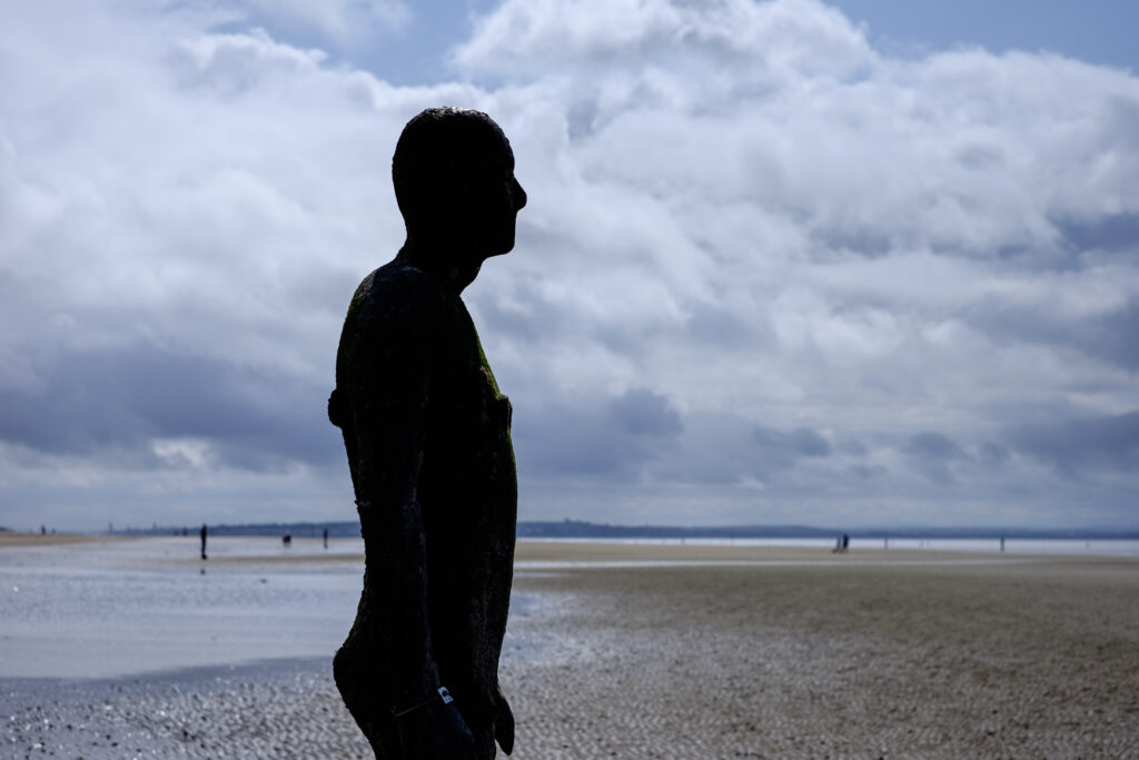 England, Merseyside, Antony Gormley Another Place. Antony Gormley sculptures at Crosby Beach near Liverpool in England.