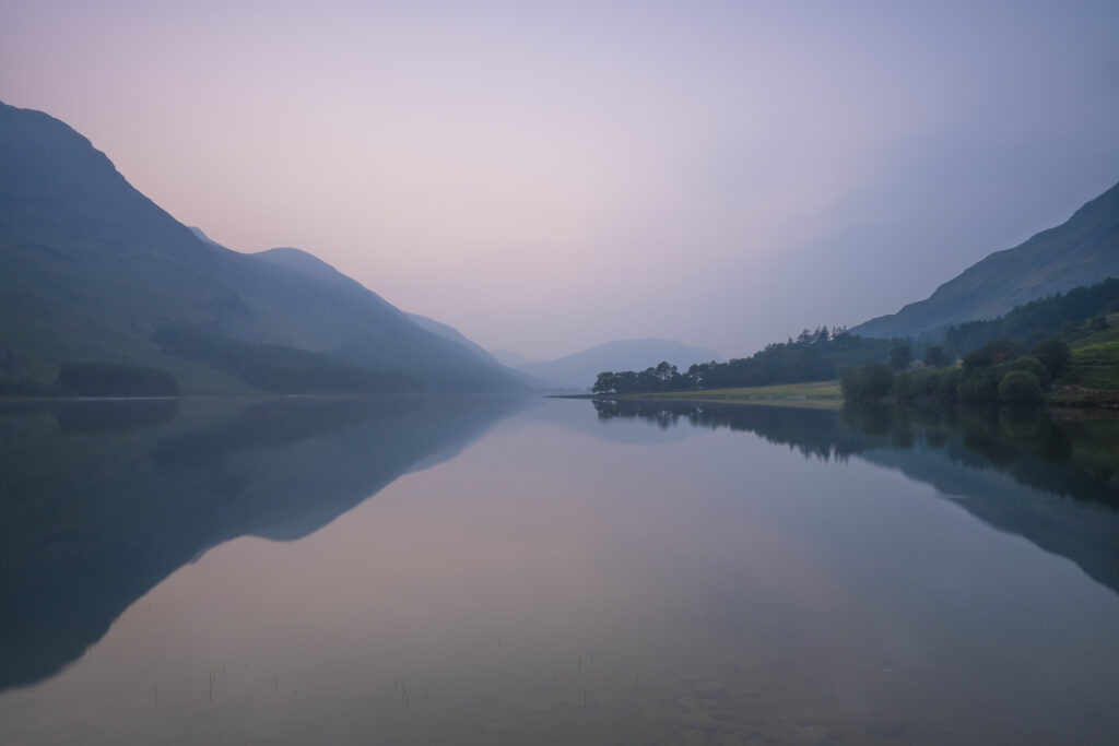 England, Cumbria, Lake District National Park. Buttermere at dusk, on a misty summers day.