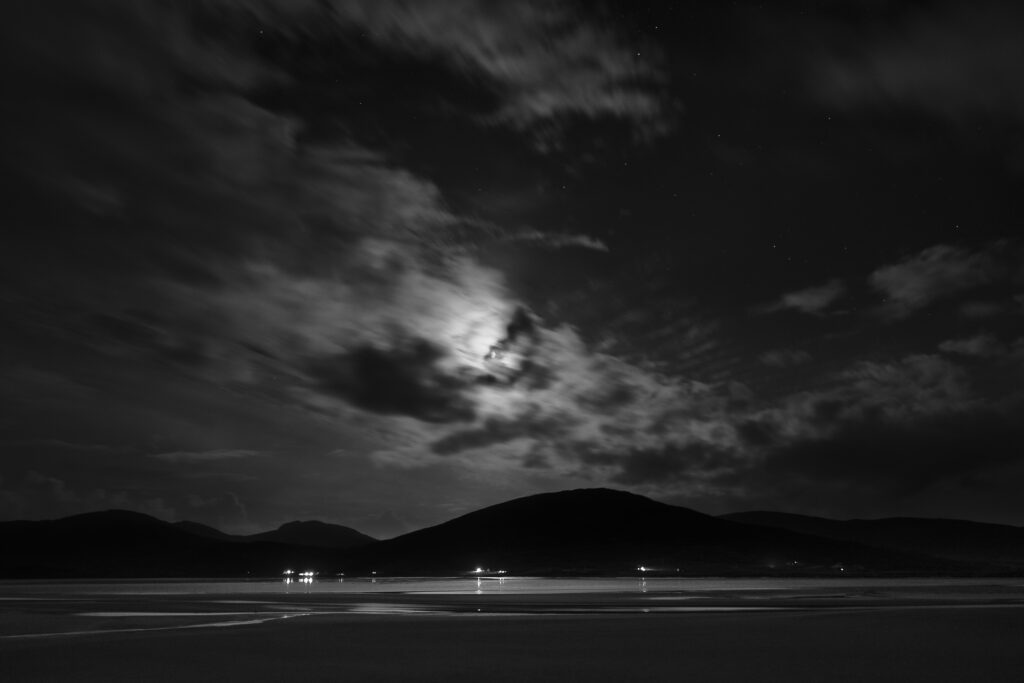 Scotland, The Isle of Harris, Seilebost. A starry night over the Lusketyre Bay on the Luskentyre peninsula looking towards Seilebost.