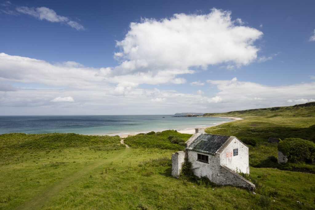 Northern Ireland, Country Antrim, White Park Bay. An abandoned Youth Hostel overlooking White Park Bay part of the Giants Causeway World Heritage Site (UNESCO).