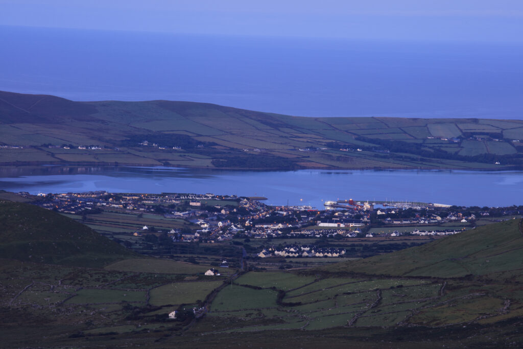 Republic of Ireland, County Kerry, Dingle. Early morning view from Connor Hill on the Conor Pass, looking the coastal town of Dingle on the Dingle Peninsula.