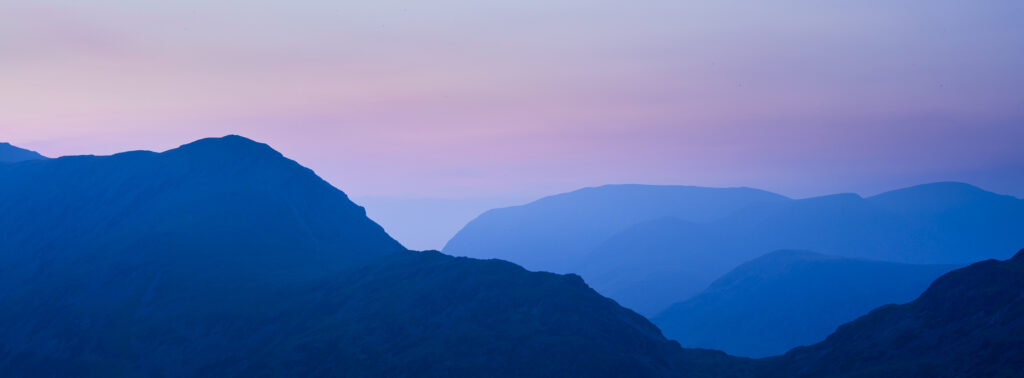 England, Cumbria, Lake District National Park. Dusk over the mountains of the remote North-Western Lake Distrcit National Park.