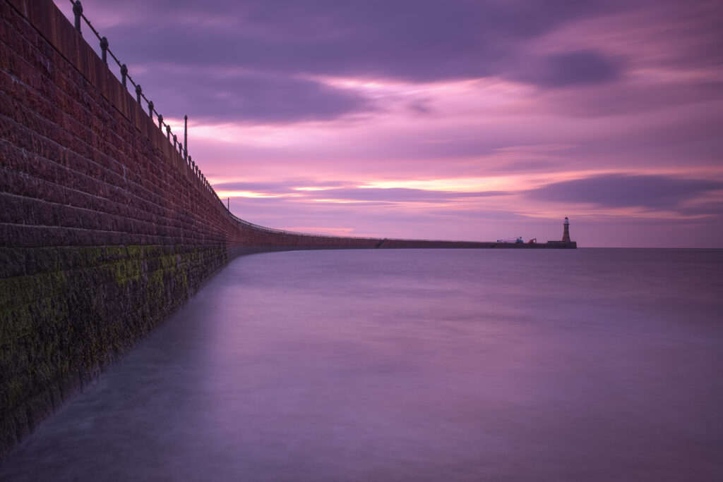 England, Tyne and Wear, Sunderland. The pink hues of a mid-summer sunrise at Roker Pier near the city of Sunderland.