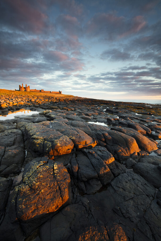 England, Northumberland, Dunstanburgh Castle. Dunstanburgh Castle at dawn, located along the Northumberland Heritage Coast.