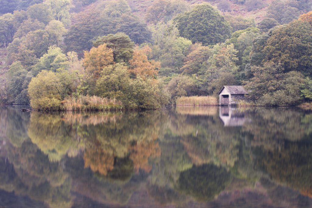 England, Cumbria, Lake District National Park. Early morning reflections at Rydal Water, on a still autumn day.