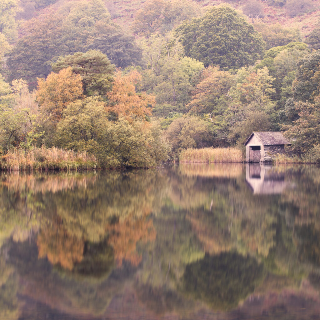 England, Cumbria, Lake District National Park. Early morning reflections at Rydal Water, on a still autumn day.