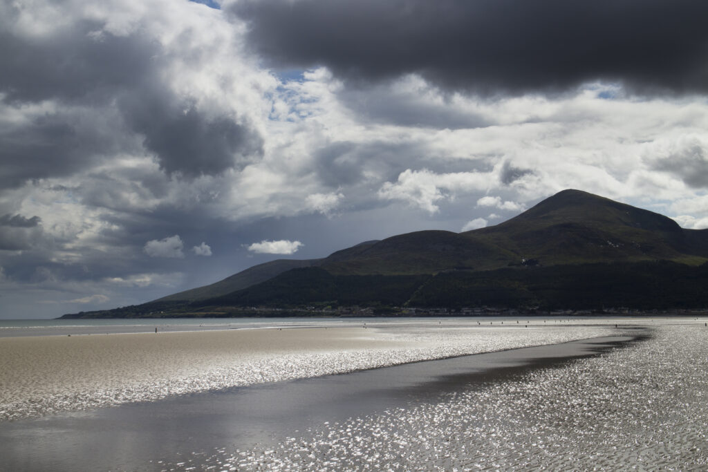 Northern Ireland, County Down, Murlough Beach. Storm clouds above Murlough Bay and the overlooking Mourne Mountains