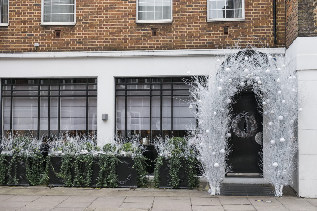 England, London, The Royal Borough of Kensington and Chelsea, Christmas Decorations. Christmas decorations outside a business in Chelsea.