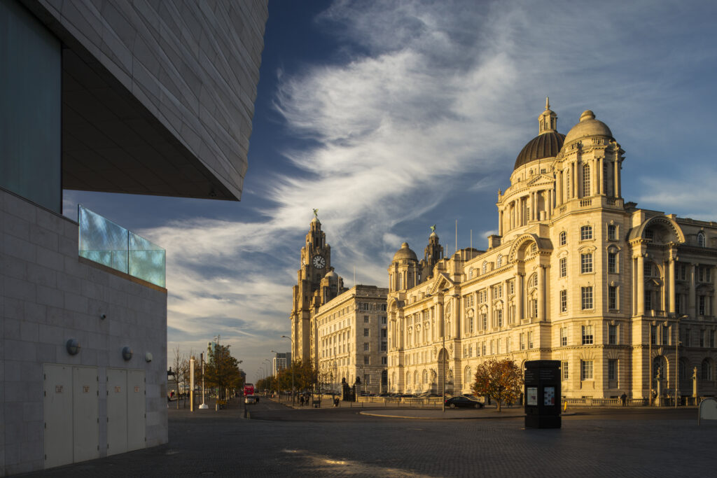 England, Merseyside, Liverpool. The Royal Liver Building, Cunard Building and Port of Liverpool Building (also known as Liverpool's Three Graces) viewed from alongside the Museum of Liverpool. The buildings are part of the Liverpool Maritime Mercantile City UNESCO World Heritage Site.
