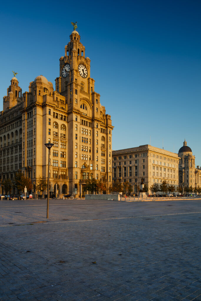 England, Merseyside, Liverpool. The Royal Liver Building, Cunard Building and Port of Liverpool Building (also known as Liverpool's Three Graces) viewed from pier head in Liverpool. The buildings are part of the Liverpool Maritime Mercantile City UNESCO World Heritage Site.