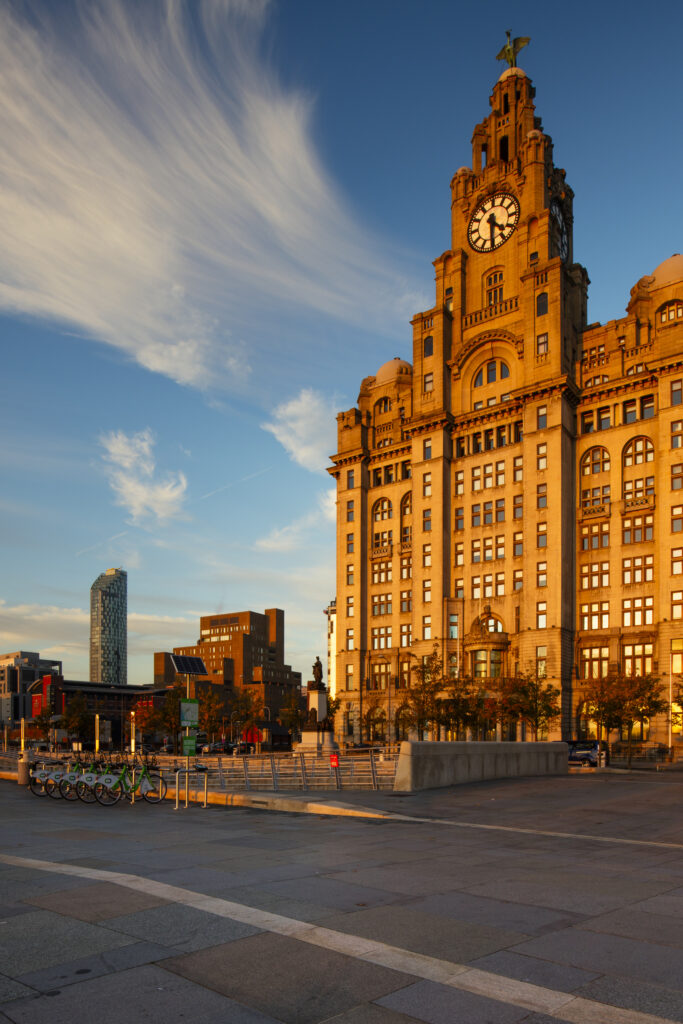 England, Merseyside, Liverpool. The Royal Liver Building, (which with the neighboring Cunard Building and Port of Liverpool Building forms the Liverpool's Three Graces) viewed from pier head in Liverpool. The buildings are part of the Liverpool Maritime Mercantile City UNESCO World Heritage Site.
