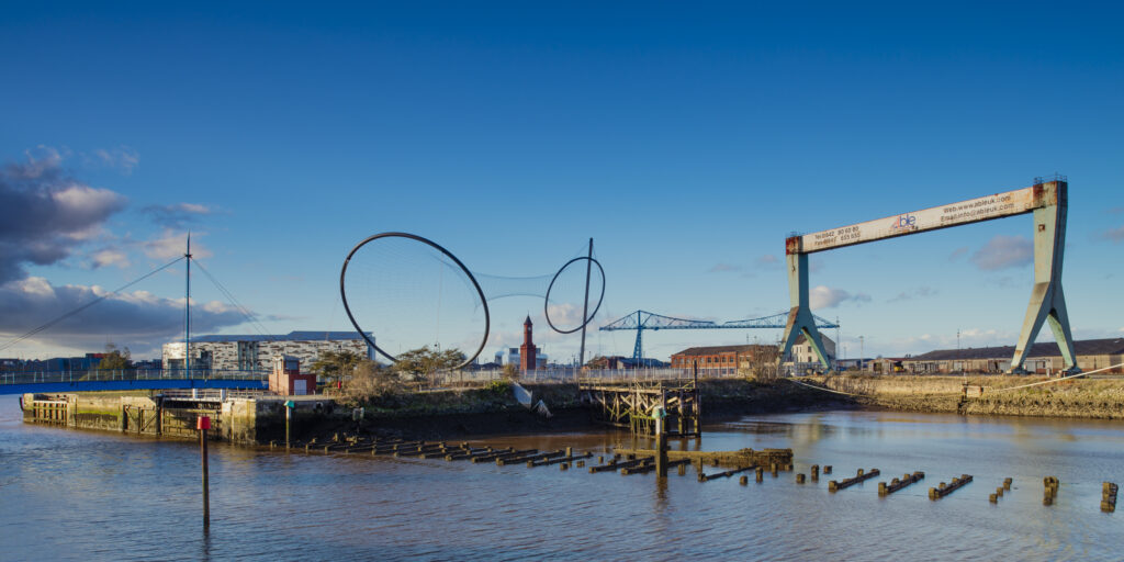 England, Middlesbrough, Middlehaven Quayside Regeneration. The new Middlesbrough College building, Anish Kapoor sculpture Temenos, Middlesbrough Clock Tower and Middlesbrough Transporter Bridge - All part of the Middlehaven regeneration area of Middlesbrough.