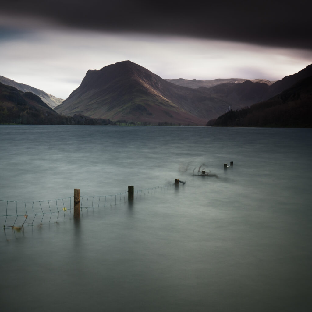 England, Cumbria, Lake District National Park. Storm clouds above Lake Buttermere on a late autumn morning.