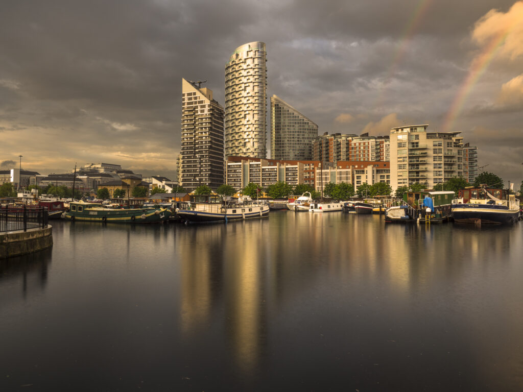 England, Greater London, London City. Storm clouds above Blackwall Basin, part of an inland waterway forming part of the Canary Wharf financial district.