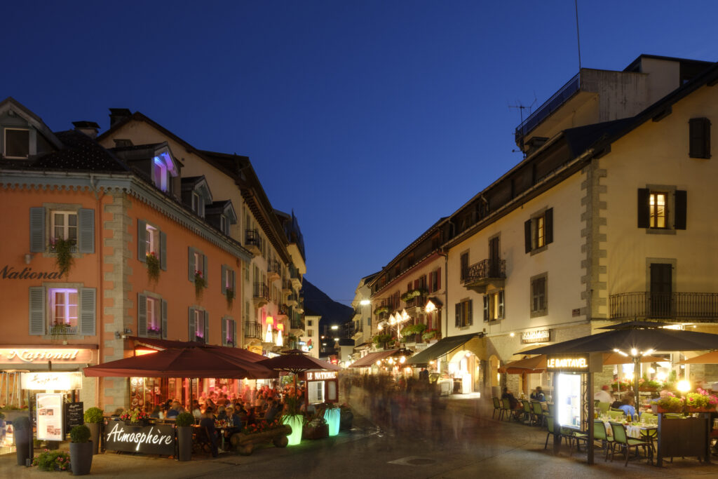 France, French Alps, Chamonix-Mont-Blanc. A busy street scene of cafes and restuarants in the town of Chamonix, a popular summer and winter destination in the French Alps located near Europe's highest mountain - Mont Blanc.