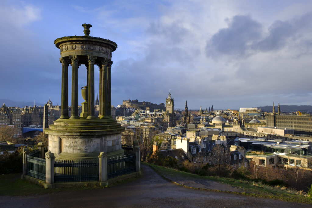 Scotland, Edinburgh, Calton Hill. The Dugald Stewart Monument on Calton Hill, looking towards the Castle and Old Town of Edinburgh.