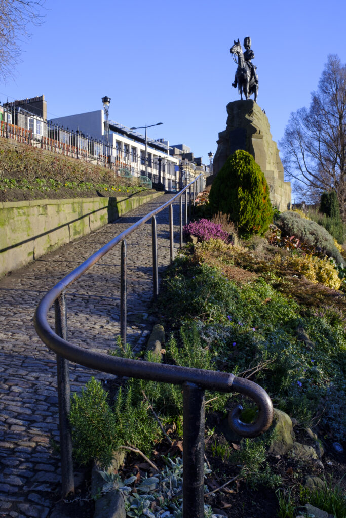 Scotland, Edinburgh, West Princes Street Gardens. Pathway leading to Princes Street near a monument erected in memory of the Royal Scots Greys,