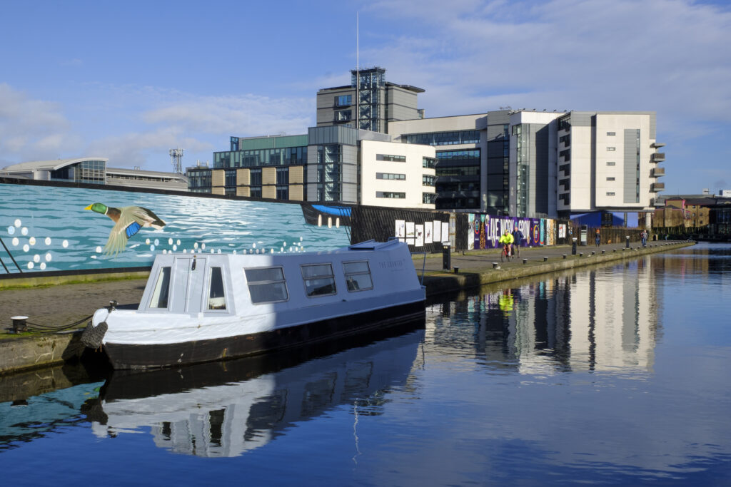 Scotland, Edinburgh, Union Canal. Canal Boat moored near the Lochrin Basin on the Union Canal near Fountainbridge. Now known as the Edinburgh Quay, the site has seen recent redevelopment and a number of bars and apartments are situated along the quayside.
