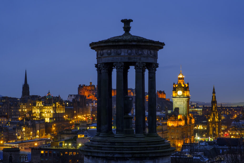 Scotland, Edinburgh, Calton Hill. The Dugald Stewart Monument on Calton Hill, looking towards the Castle and Old Town of Edinburgh.