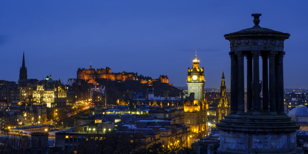 Scotland, Edinburgh, Calton Hill. The Dugald Stewart Monument on Calton Hill, looking towards the Castle and Old Town of Edinburgh.