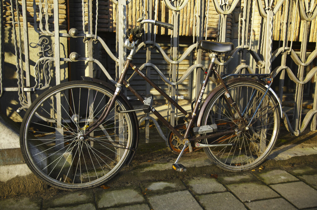 Netherlands, North Holland, Amsterdam. Bicycle chained to railings outside a building in Amsterdam City.