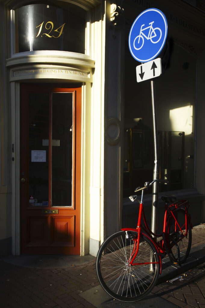 Netherlands, North Holland, Amsterdam. Bicycle left outside a traditional style shop in Amsterdam City.