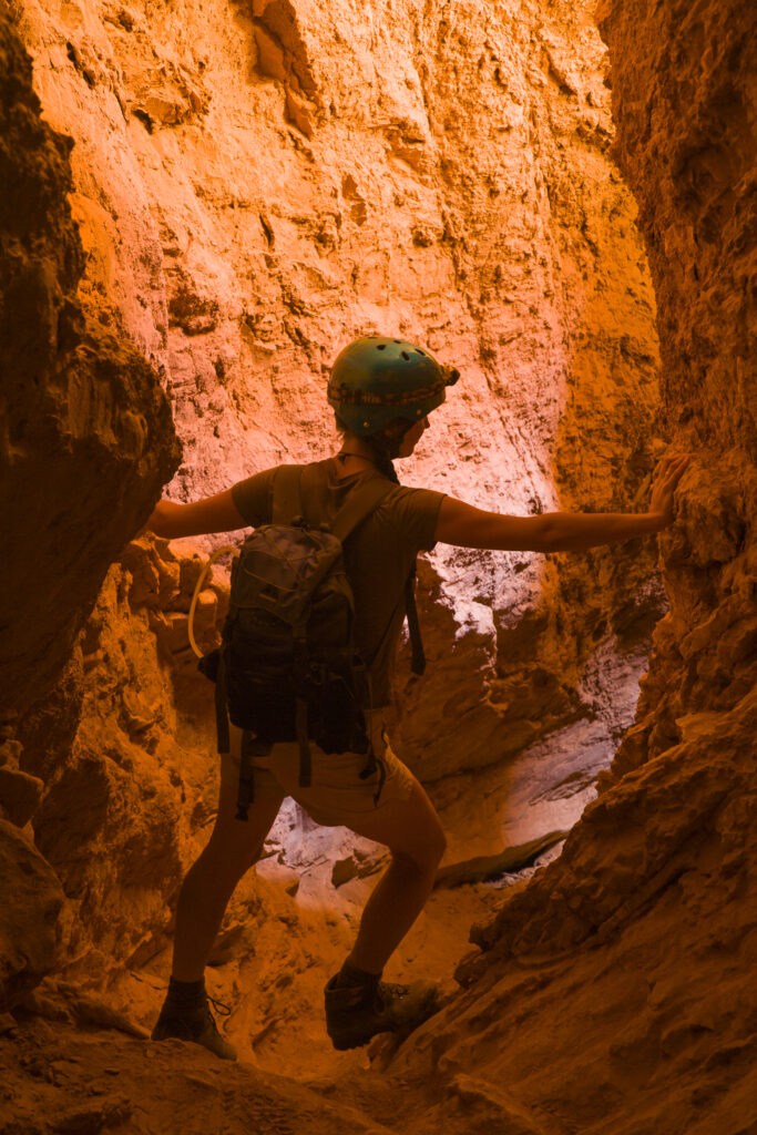 Chile, Atacama Desert, Plaza Quitor. Young woman explores the canyons in the mountains of the Atacama Desert near the Plaza Quitor.