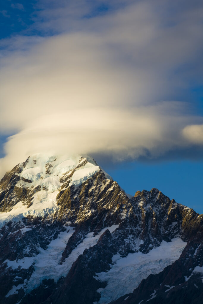 New Zealand, Canterbury, Mt Cook National Park. Storm clouds hug the peak of the mighty Mt Cook (known to the Maori as Aoraki) the highest peak in Australasia at 3755M.