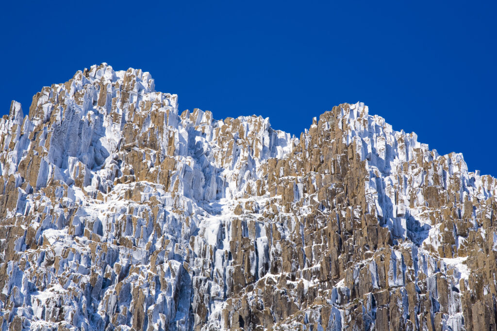 Australia, Tasmania, Cradle Mt - Lake St Clair National Park. Snow and ice covered dolerite columns forming Cradle Mountain.
