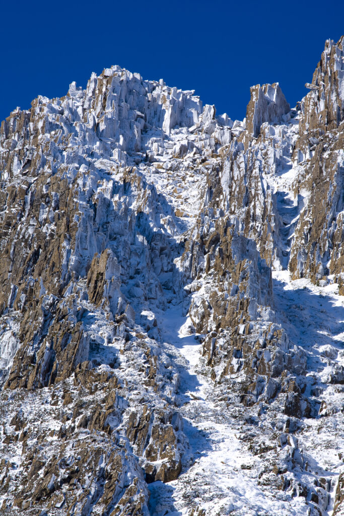 Australia, Tasmania, Cradle Mt - Lake St Clair National Park. Snow and ice covered dolerite columns forming Cradle Mountain.