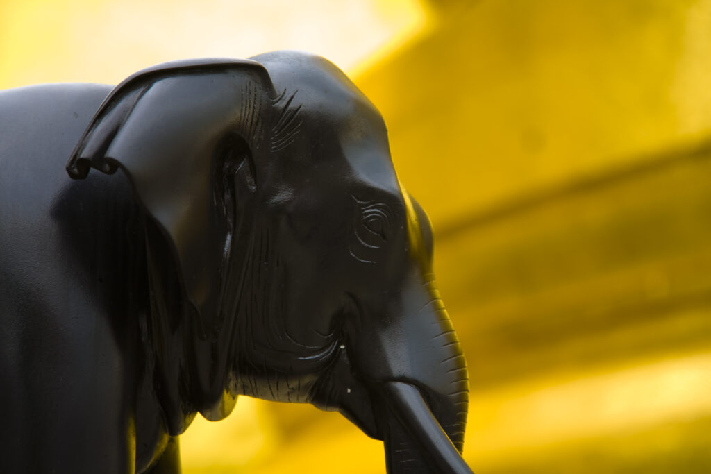 Thailand, Bangkok, The Grand Palace. Elephant statue in the ornate setting of the golden grand palace.