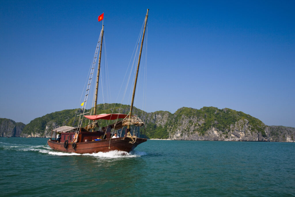 Vietnam, Northern Vietnam, Halong Bay. Tourist boat amid the islands of Halong Bay near Cat Ba Island.