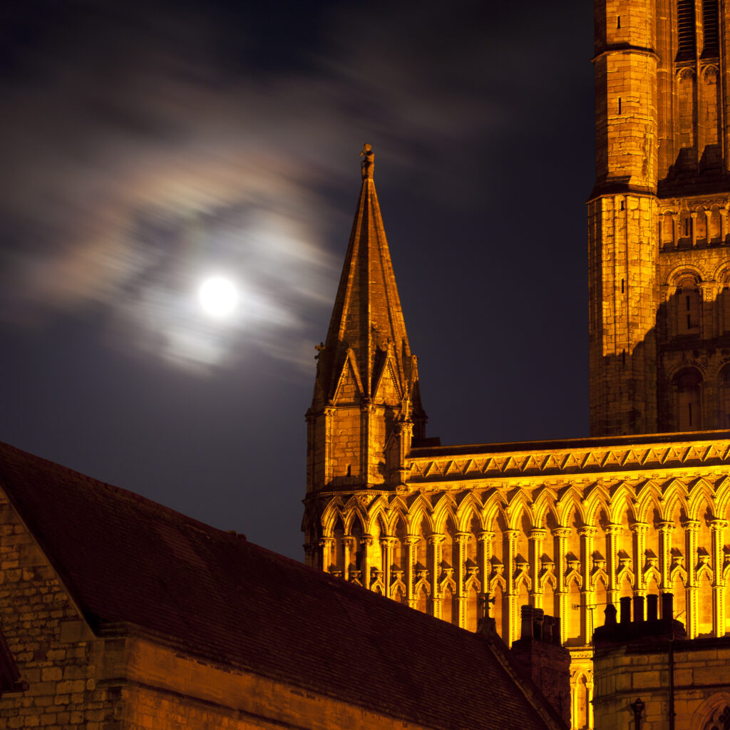 England, Lincolnshire, Lincoln. Full moon behind Lincoln Cathedral in the historic UK city of Lincoln.