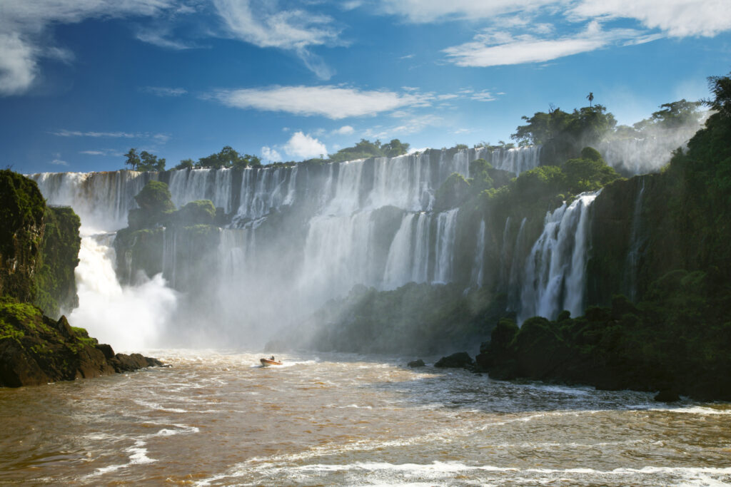 Argentina, Misiones, Iguazu National Park. Tourist boat trip near the impressive Iguazu waterfalls - A world heritage site.